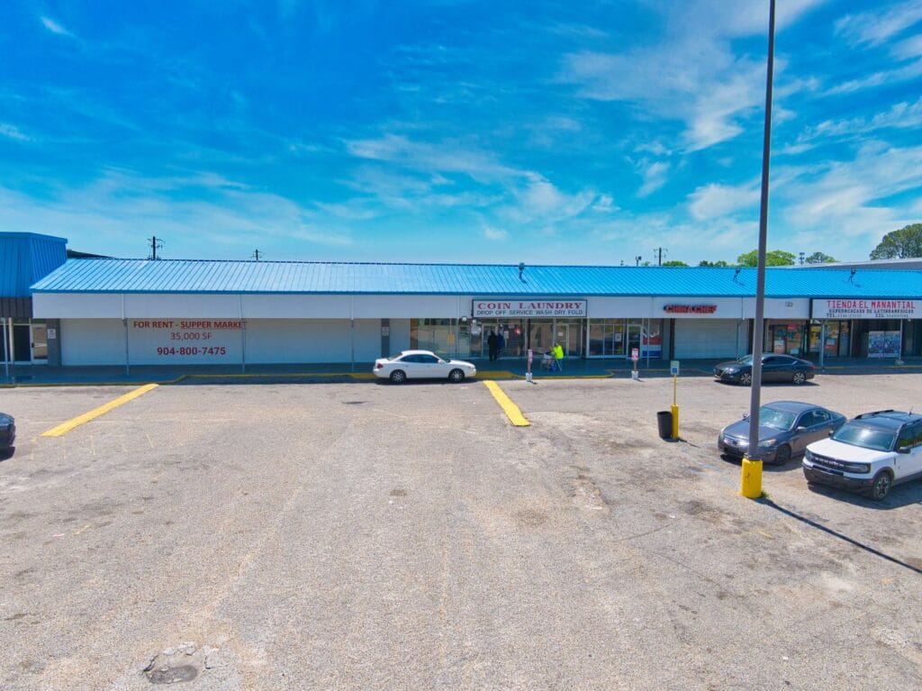 Exterior view of Normendale Shopping Center showcasing the storefronts and parking area.