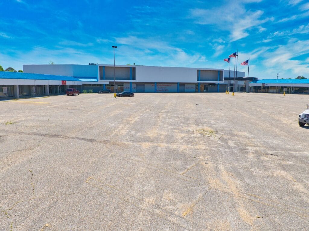 A modern shopping center with a variety of stores and a spacious parking lot, showcasing the Normendale Shopping Center.
