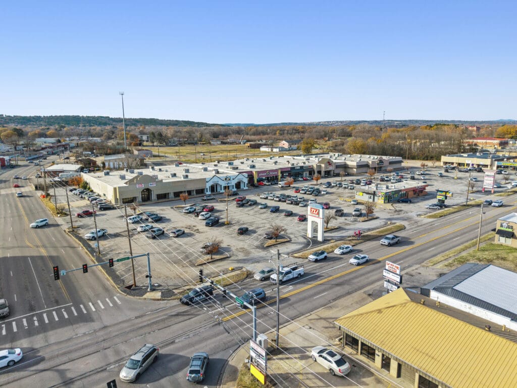 Exterior view of City Mall Retail Center featuring multiple storefronts and a clear blue sky.