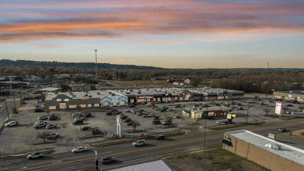 Exterior view of City Mall Retail Center showcasing storefronts and signage in Russellville, AR.
