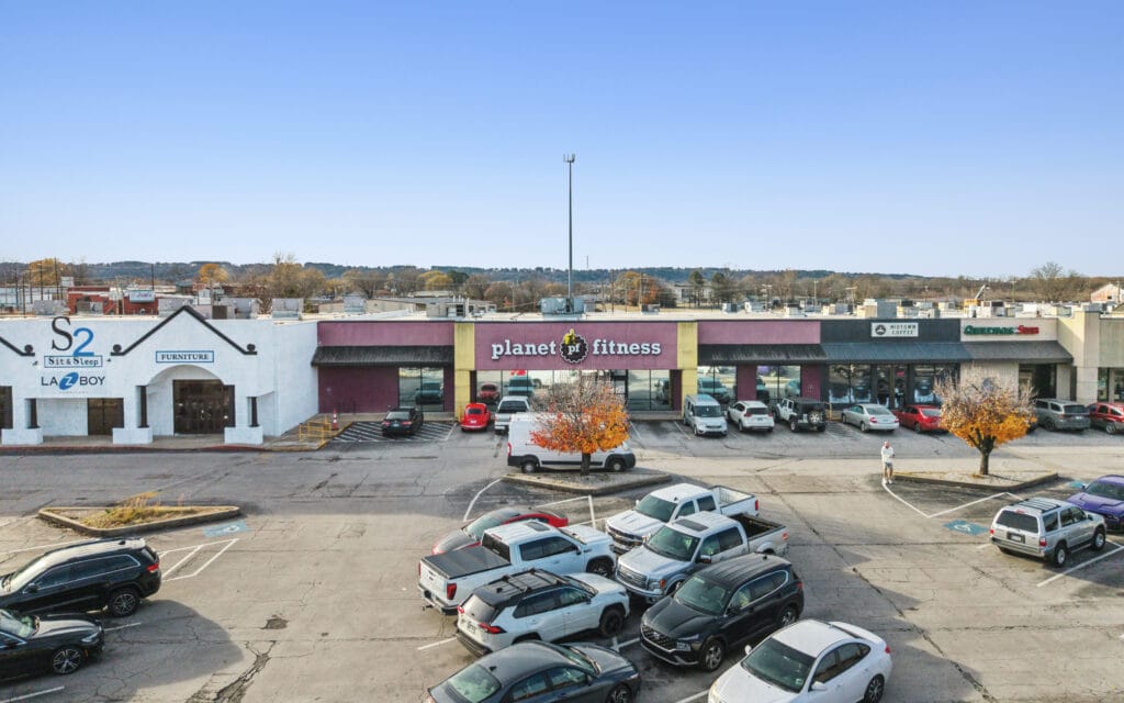 A retail center in Russellville, AR, showcasing modern architecture and storefronts, ideal for shopping.