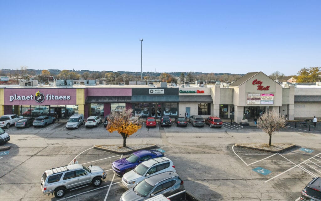 Exterior view of City Mall Retail Center showcasing storefronts and signage in Russellville, AR.