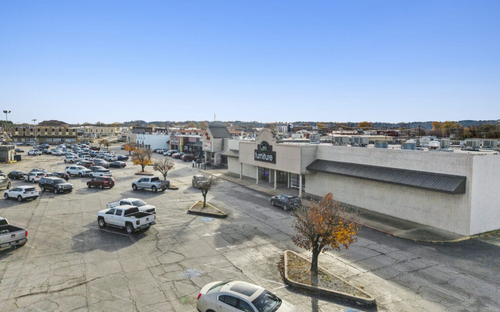 Exterior view of City Mall Retail Center, showcasing storefronts and signage in a bustling shopping area.