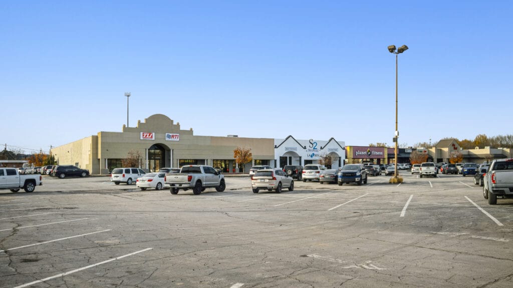 Retail center exterior at 407 N Arkansas Ave, Russellville, AR, showcasing modern architecture and storefronts.