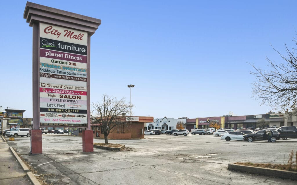 Exterior view of the retail center at 407 N Arkansas Ave, Russellville, AR, showcasing modern architecture and signage.
