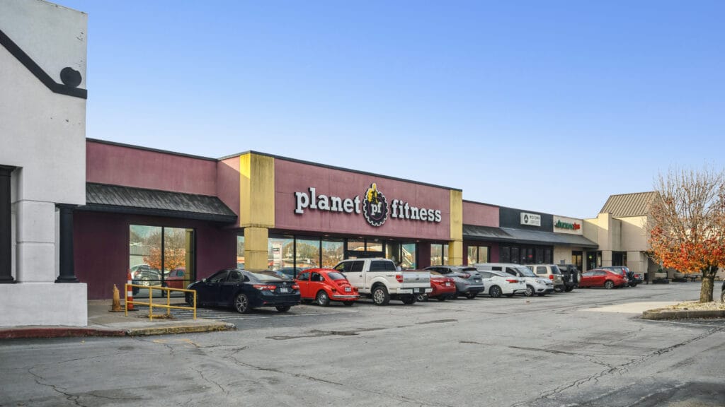 Exterior view of 407 N Arkansas Ave, Russellville, AR 63, showcasing the retail center's entrance and signage.