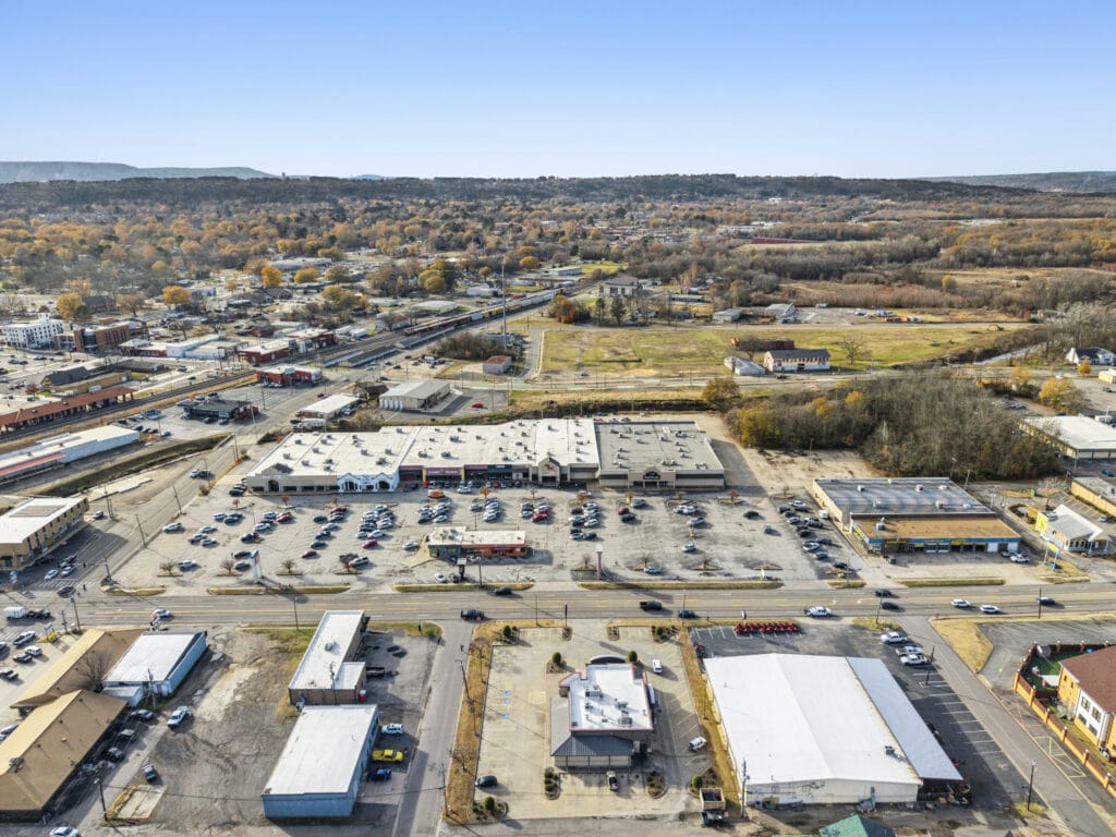 Exterior view of City Mall Retail Center showcasing storefronts and parking area, ideal for shopping and leisure.