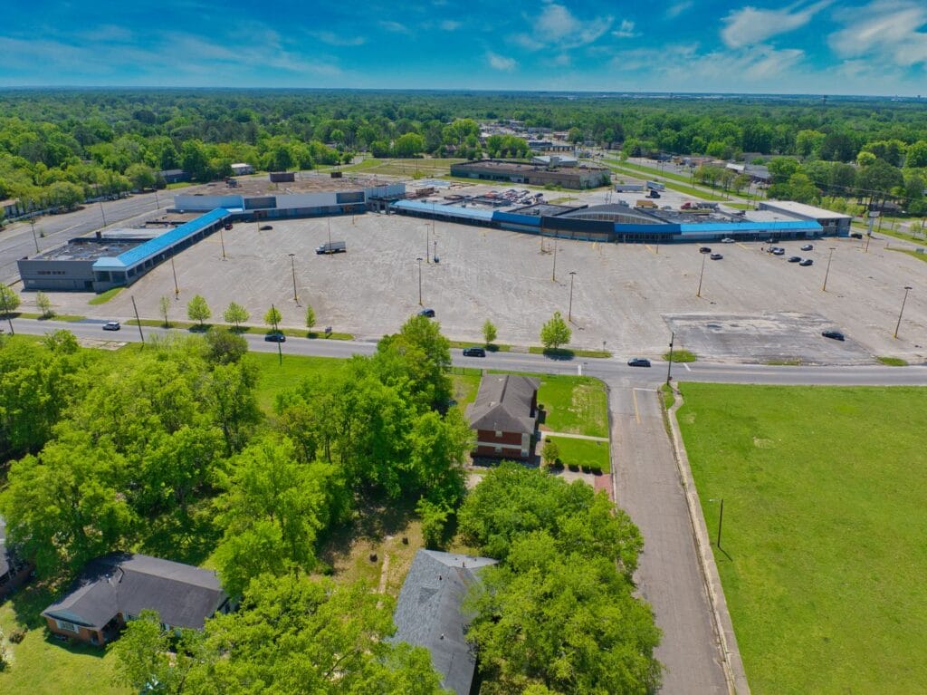The Normendale Shopping Center features a modern architectural design with storefronts and ample parking, showcasing retail o