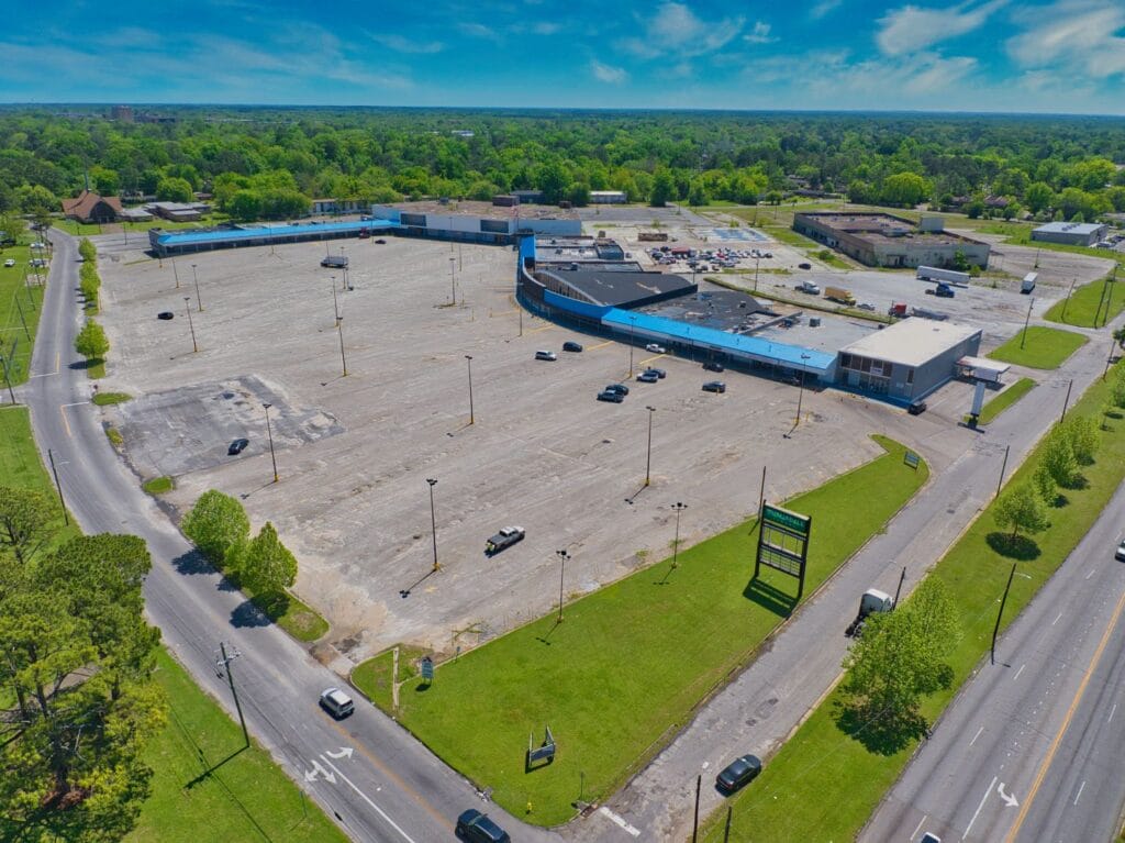 A view of Normendale Shopping Center showcasing storefronts and parking, highlighting the vibrant shopping experience.