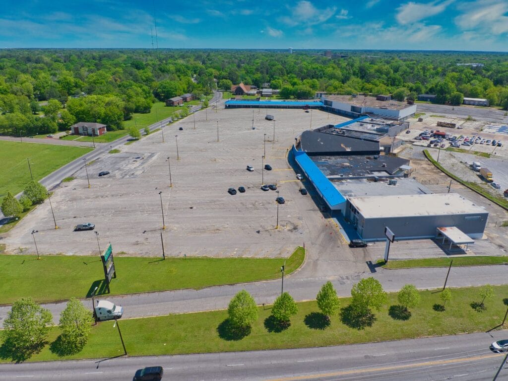 A view of Normendale Shopping Center showcasing various storefronts and parking spaces, highlighting its vibrant retail envir