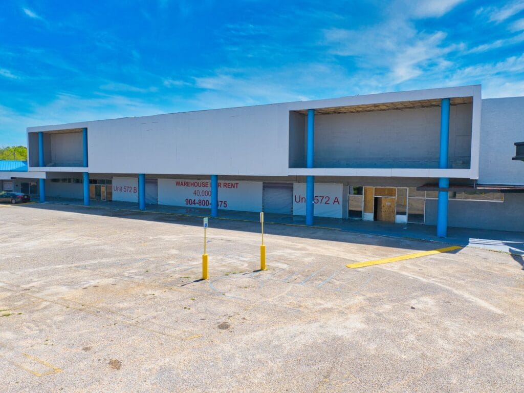 A modern shopping center with various storefronts, showcasing a vibrant community space at Normendale Shopping Center.