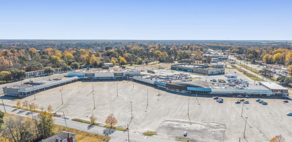 The Normendale Shopping Center features a modern design with storefronts and ample parking, showcasing a vibrant shopping atm