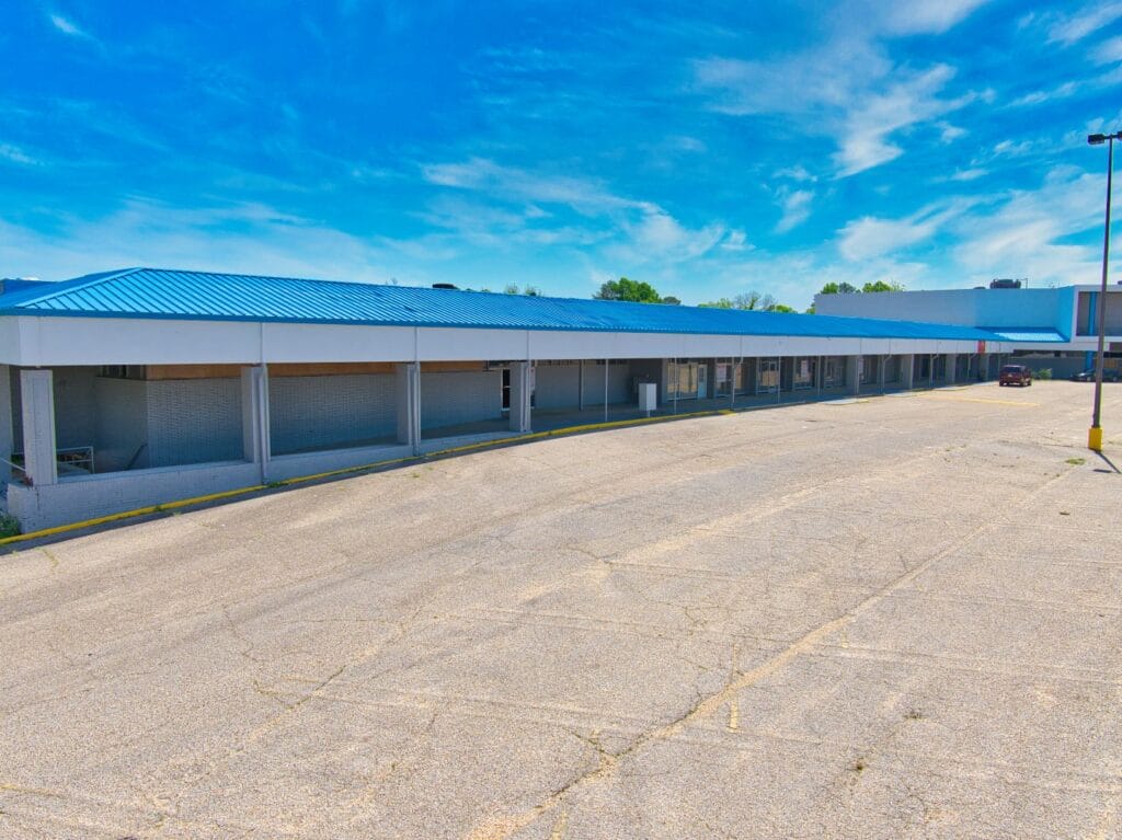 A retail space at Normendale Shopping Center featuring large windows and a welcoming entrance.