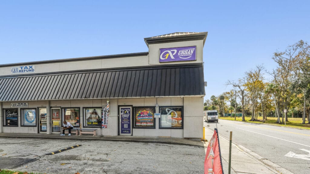 Exterior view of 955 Orange Ave, Daytona Beach, showcasing the shopping center's architecture and signage.