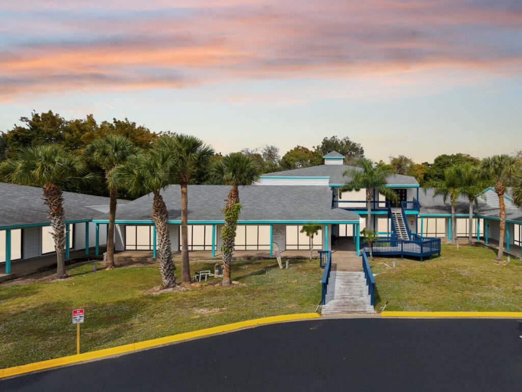 Exterior view of Village Plaza, showcasing modern architecture and landscaping in Daytona Beach, FL.
