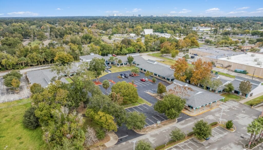 A modern residential building with multiple balconies and large windows, showcasing the 1128 village1 property.