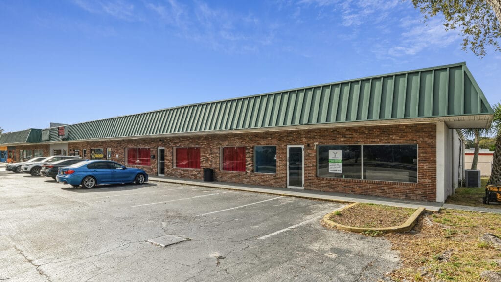 Exterior view of 1210 N Nova Rd in Daytona Beach, showcasing a modern building with clear blue skies.