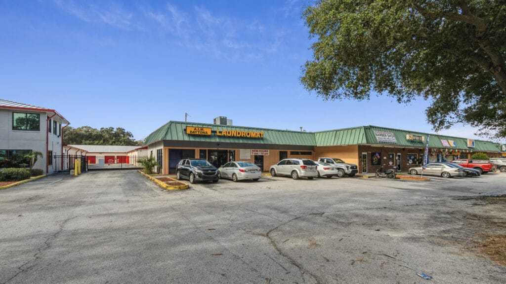 Exterior view of 1210 N Nova Rd, Daytona Beach, showcasing the building's architecture and surrounding landscape.