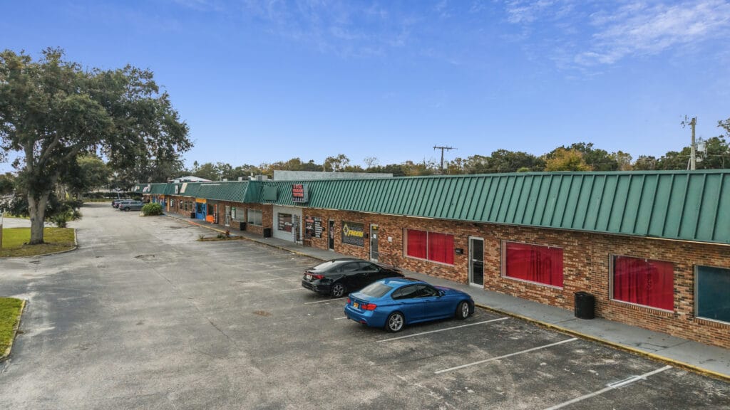 A commercial property located at 1210 N Nova Rd, Daytona Beach, showcasing its exterior and surrounding landscape.