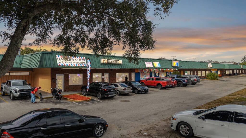Exterior view of Daytona Plaza, showcasing the building's architecture and surrounding landscaping.