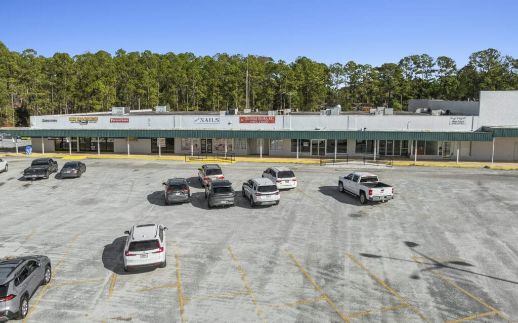 A modern commercial building at Sunset Plaza in Moultrie, GA, featuring large windows and a welcoming entrance.
