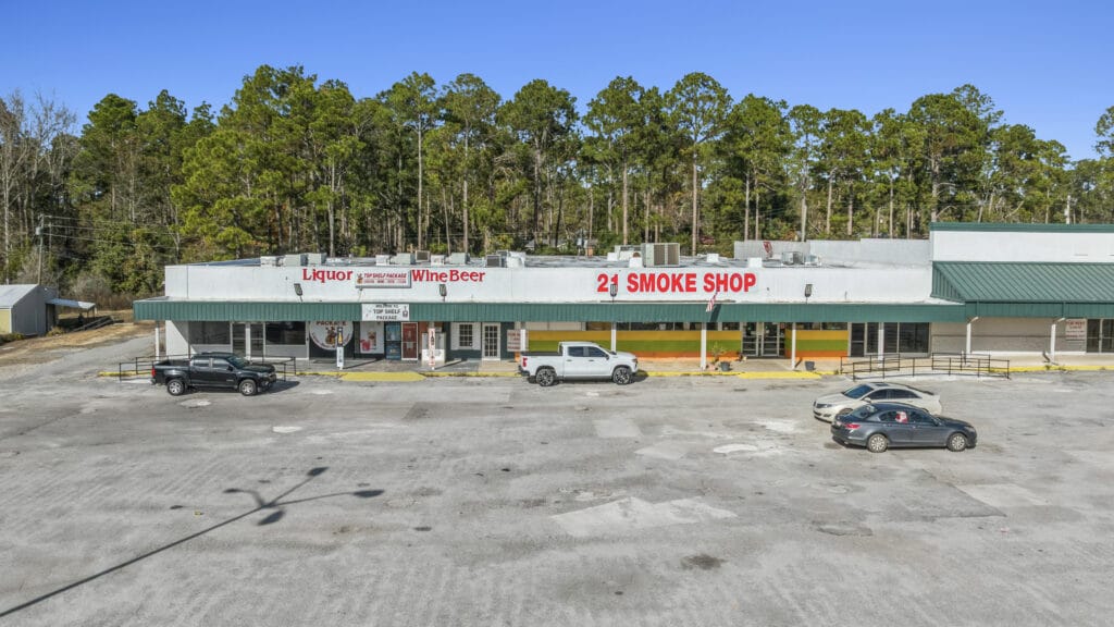 Exterior view of Sunset Plaza in Moultrie, GA, showcasing the building's architecture and surrounding landscape.