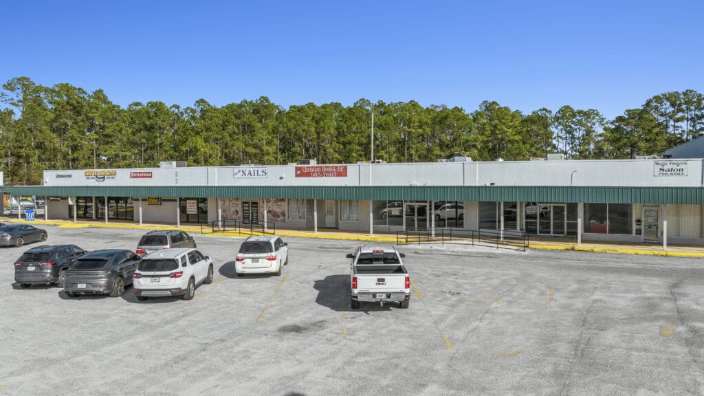 A scenic view of Sunset Plaza in Moultrie, GA, featuring vibrant sunset colors and surrounding greenery.