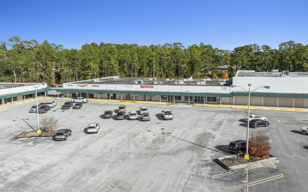 Exterior view of Sunset Plaza in Moultrie, GA, showcasing the building's modern architecture and surrounding landscape.