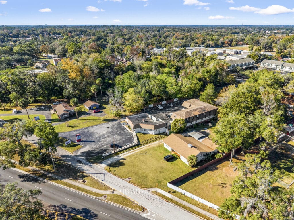 A spacious living area in a modern Ocala Main property, featuring large windows and stylish furnishings.
