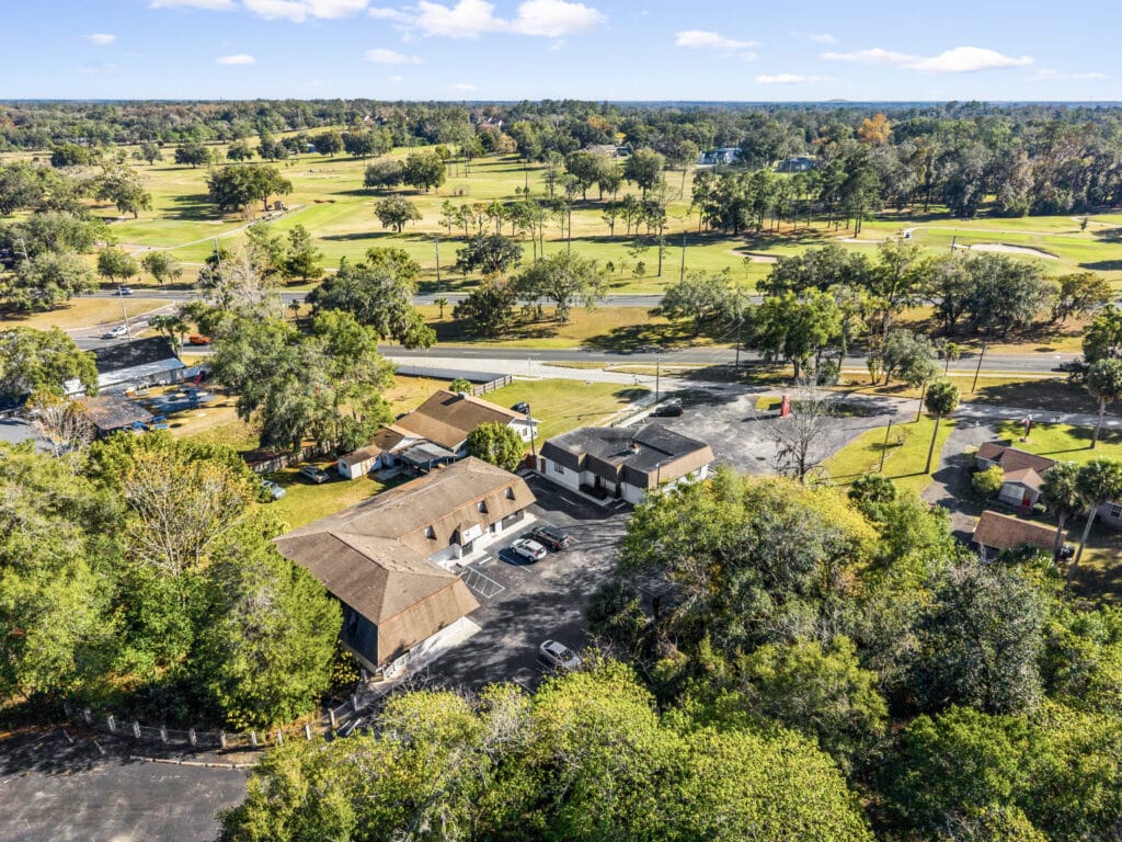 A spacious living room in Ocala, featuring large windows, a comfortable sofa, and modern decor.