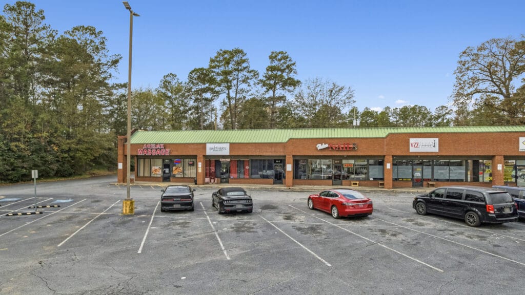 Exterior view of 3555 Mercer University Dr, showcasing a modern building with large windows and a landscaped entrance.