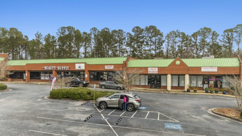 Exterior view of 3555 Mercer University Dr, showcasing a large brick building with ample parking and landscaping.