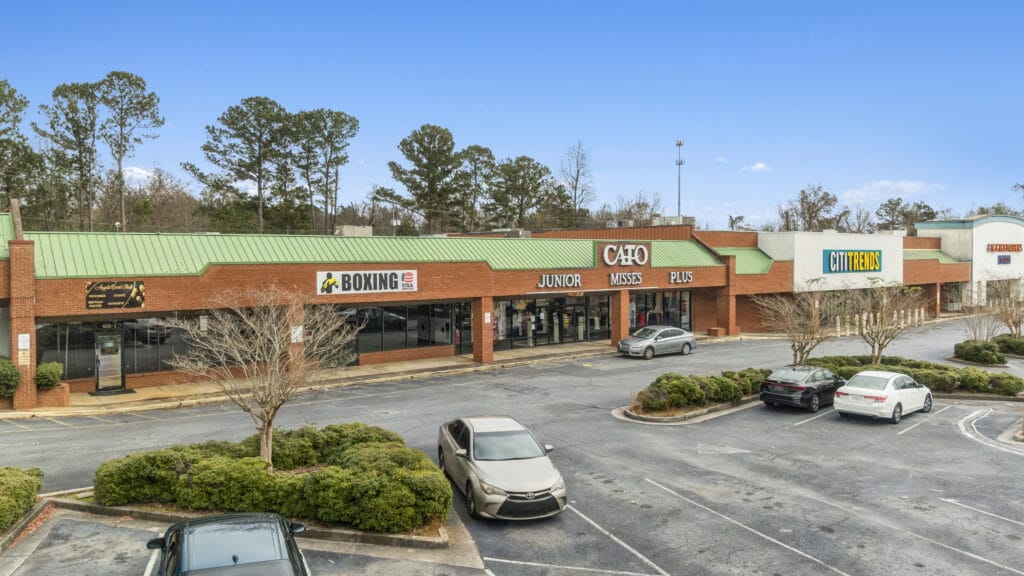 Exterior view of 3555 Mercer University Dr, showcasing a modern building with large windows and landscaping.
