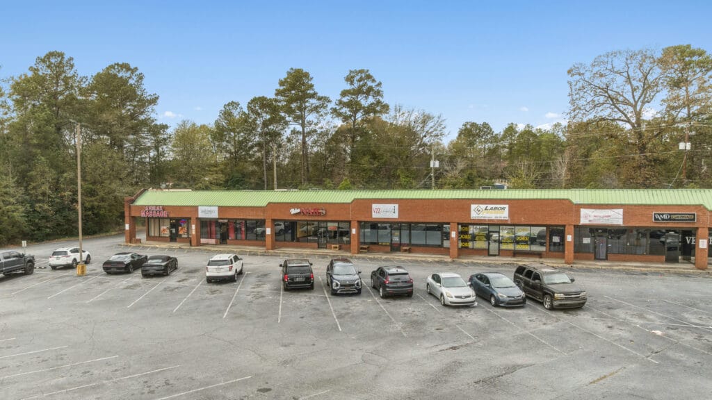 Exterior view of 3555 Mercer University Dr, showcasing a modern building with large windows and landscaping.