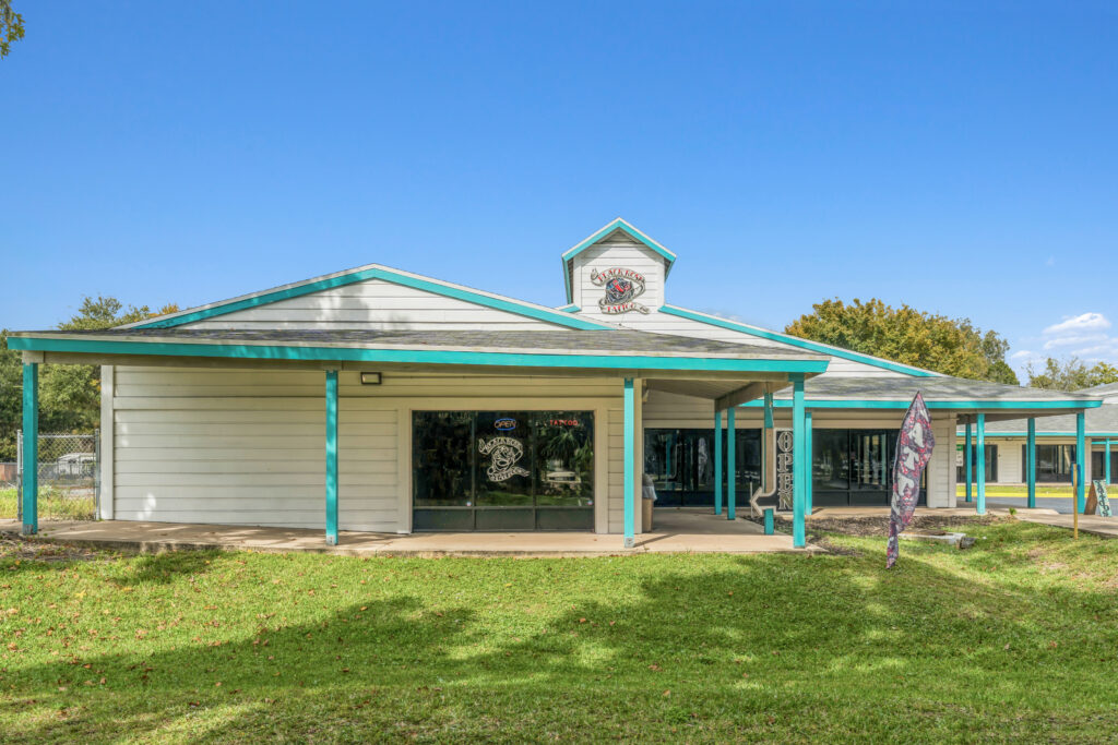 Exterior view of a property located at 1128 Beville Rd, Daytona Beach, showcasing its architecture and surrounding landscape.