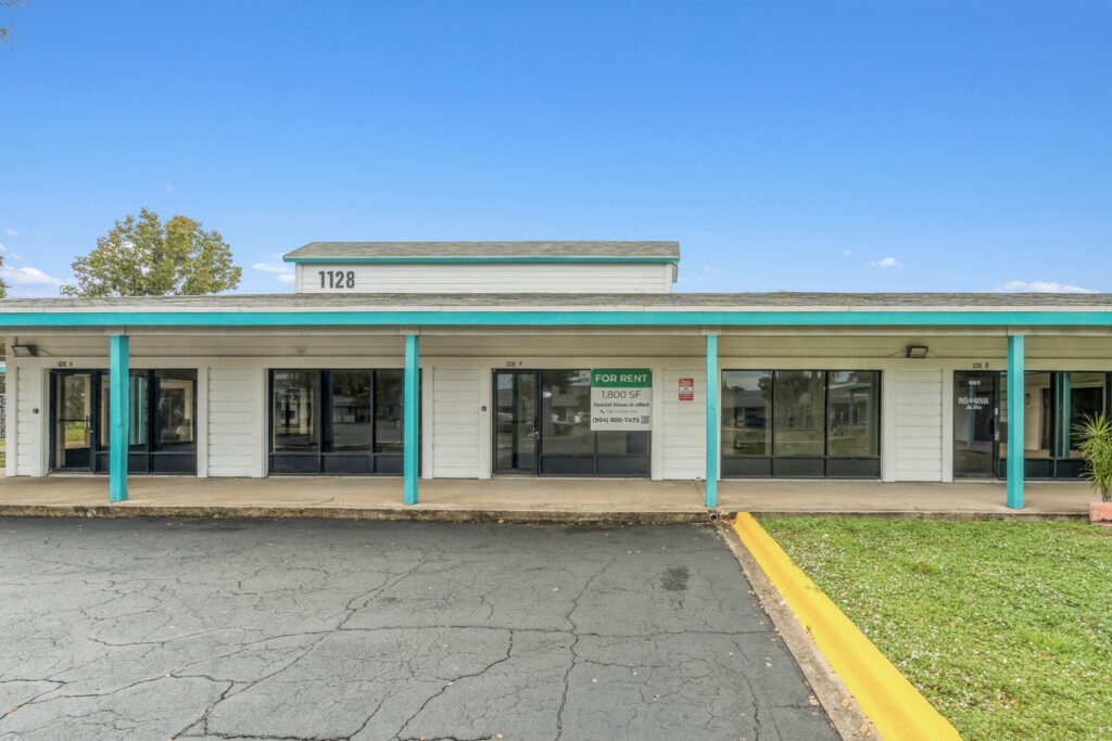 Exterior view of 39308 1128 Beville Rd, Daytona Beach, showcasing the building's architecture and surrounding landscape.