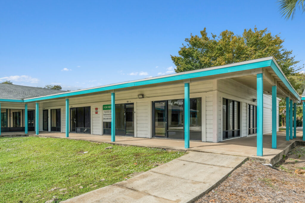 Exterior view of 39308 1128 Beville Rd, Daytona Beach, showcasing a modern building with landscaping.