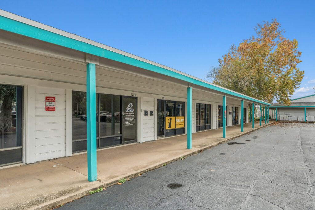 Exterior view of a commercial property at 39308 1128 Beville Rd, Daytona Beach, showcasing its architecture and surroundings.