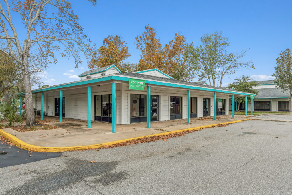 Exterior view of a property at 39308 1128 Beville Rd, Daytona Beach, showcasing the building's architecture and landscaping.