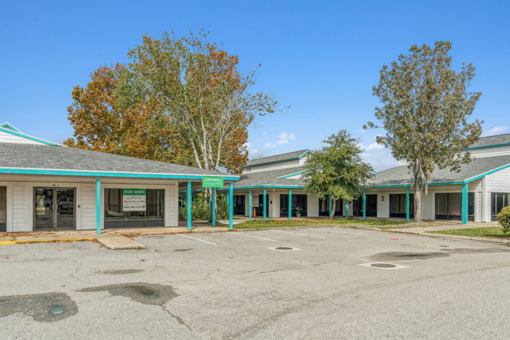Exterior view of 39308 1128 Beville Rd in Daytona Beach, showcasing the building's architecture and surrounding landscape.