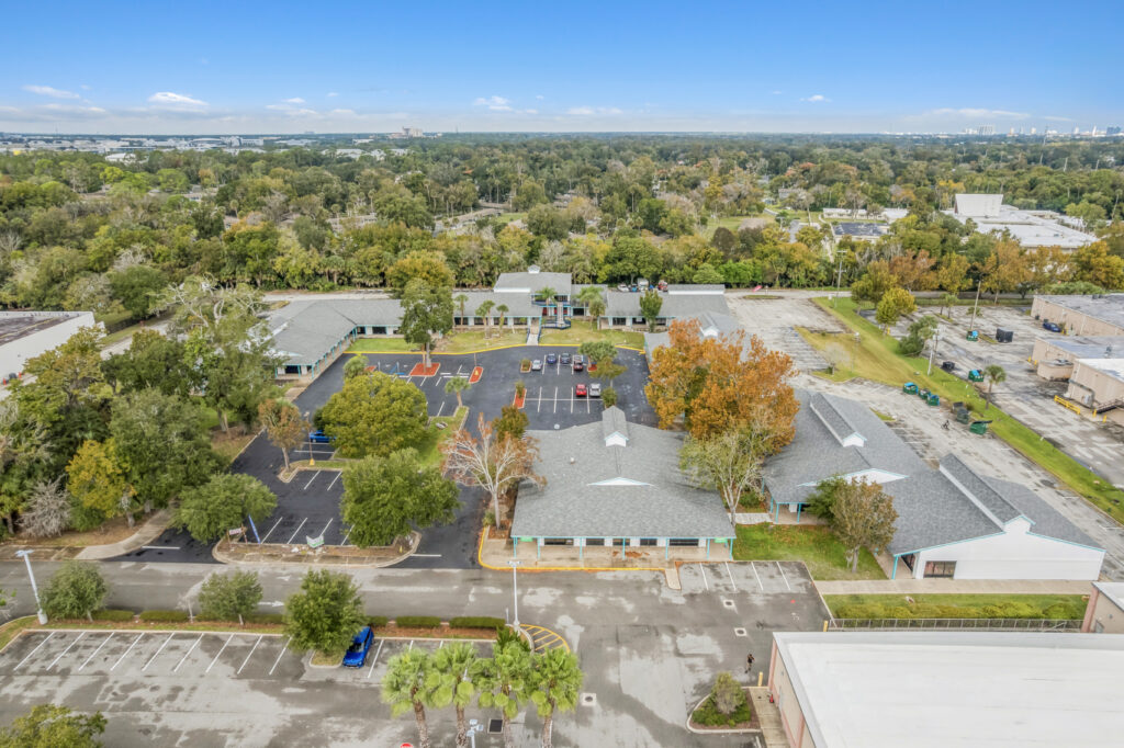 Exterior view of 39308 1128 Beville Rd in Daytona Beach, showcasing the building's architecture and surrounding landscape.