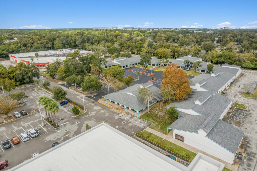 Exterior view of a commercial property at 1128 Beville Rd, Daytona Beach, showcasing its architecture and surroundings.
