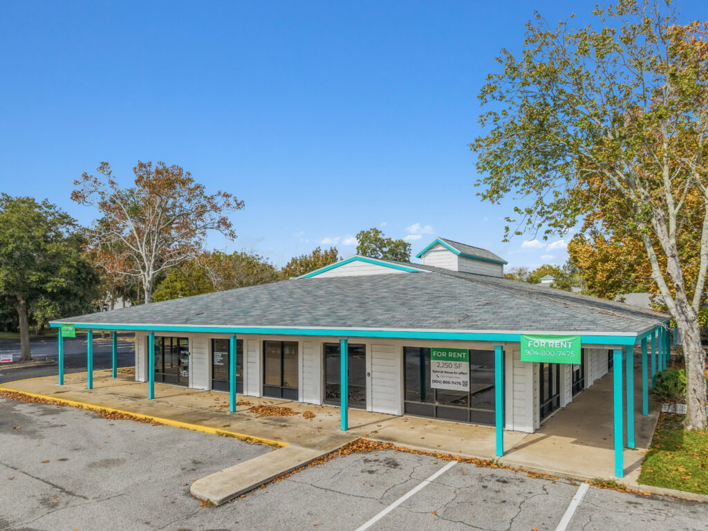 A scenic view of the Village Plaza property showcasing a well-maintained exterior with lush landscaping.