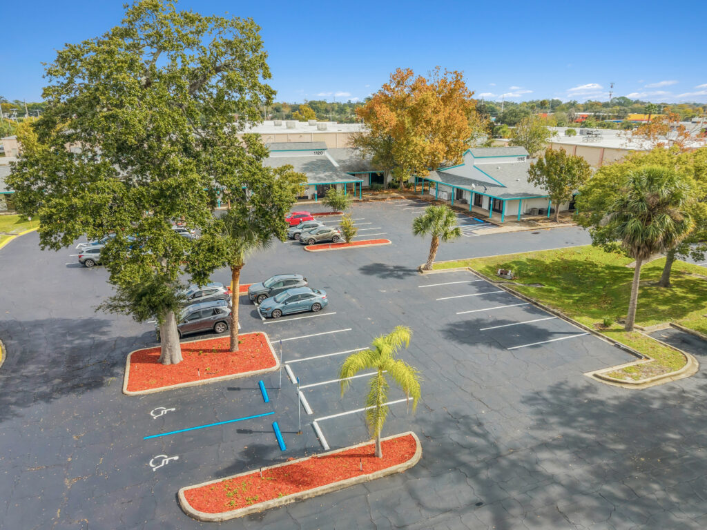 A spacious retail space in Village Plaza, showcasing large windows and a welcoming entrance in Daytona Beach.