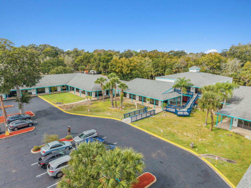Exterior view of Village Plaza in Daytona Beach, showcasing the building's architecture and surrounding landscape.