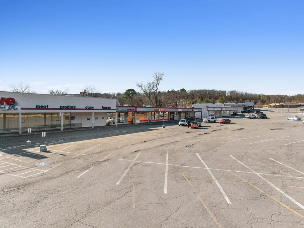 Exterior view of a modern commercial building at Pike Plaza, showcasing large windows and a welcoming entrance.