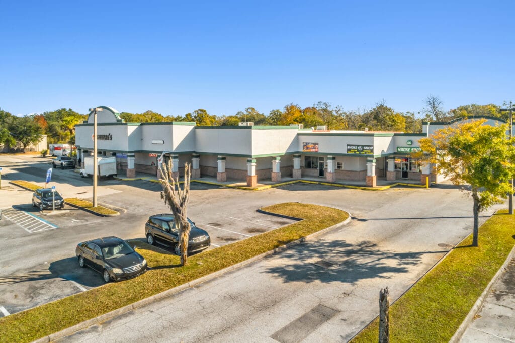 Exterior view of 40058 3118 Edgewood Ave W, showcasing a modern building with landscaping and a clear blue sky.