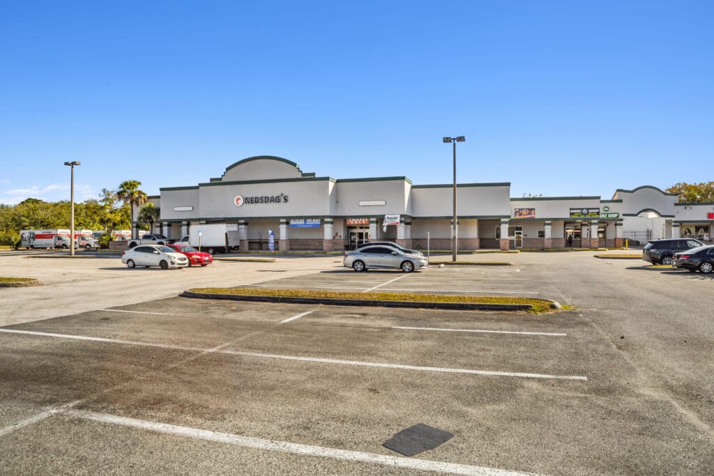 A spacious living area with modern decor, featuring large windows and natural light at 40058 3118 Edgewood Ave W.