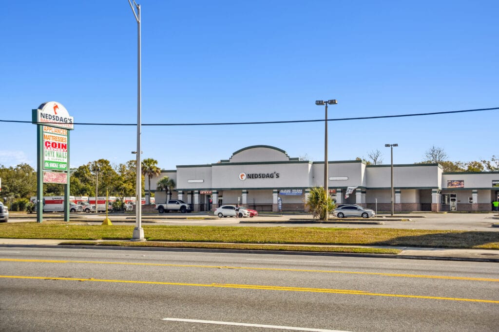Exterior view of 40058 3118 Edgewood Ave W in Jacksonville, showcasing a modern building with landscaping.