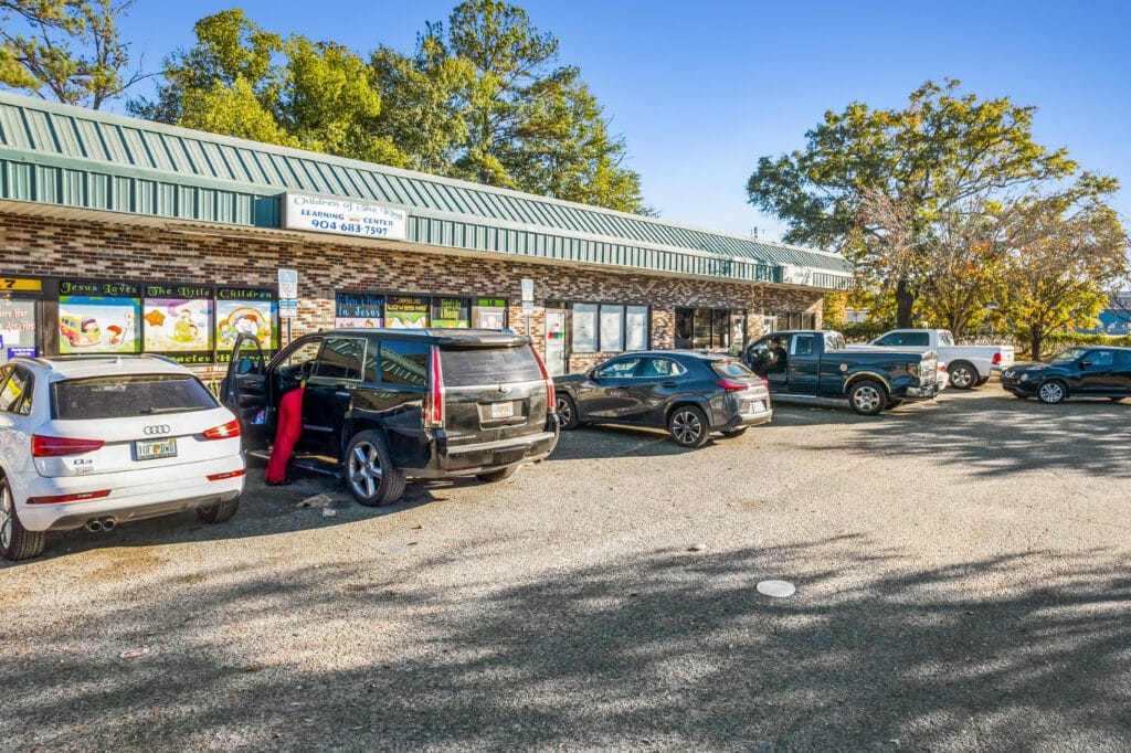 Exterior view of 40060 2851 Edgewood Ave N, Jacksonville, showcasing a modern building with large windows and landscaping.